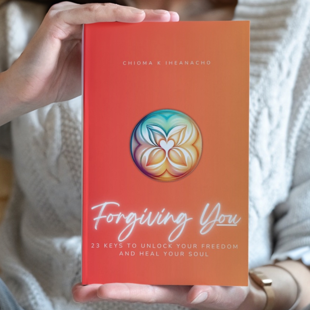 Woman holding Forgiving You by Chioma K. Iheanacho